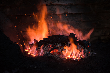 Image showing Traditional blacksmith furnace with burning fire