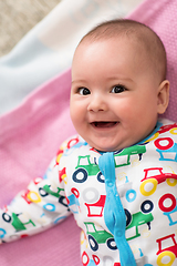 Image showing top view of newborn baby boy lying on colorful blankets