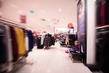 Image showing little cute girl in the clothing store