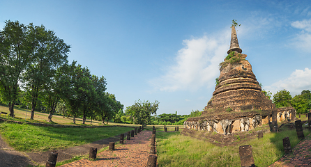 Image showing Ruins stupa with sculpted images of elephants. Panorama.Thailand