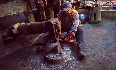 Image showing blacksmith workers using mechanical hammer at workshop