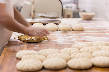 Image showing bakery worker preparing the dough