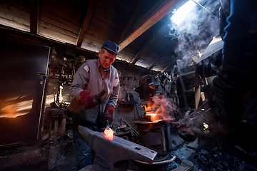 Image showing blacksmith manually forging the molten metal