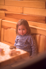 Image showing little cute girl playing near the window