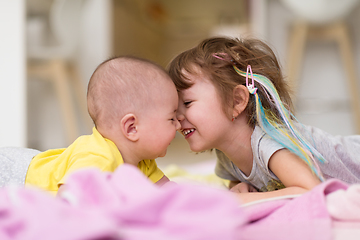 Image showing little sister and her baby brother playing at home