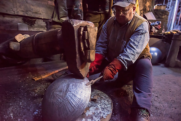 Image showing blacksmith workers using mechanical hammer at workshop