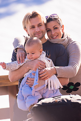 Image showing young happy family with little child enjoying winter day