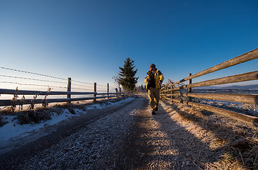 Image showing young photographer walking on country road