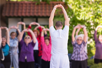 Image showing trainer training motivated active healthy senior people