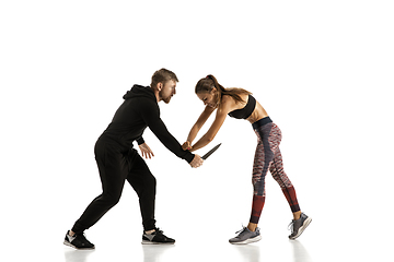 Image showing Man and woman fighting in studio, women\'s self-defense concept