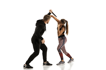 Image showing Man and woman fighting in studio, women\'s self-defense concept