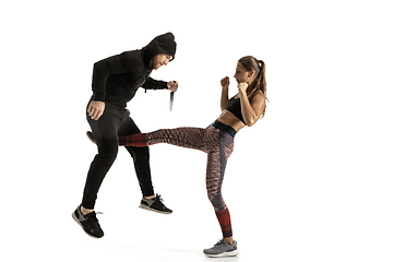 Image showing Man and woman fighting in studio, women\'s self-defense concept