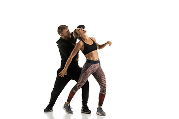 Image showing Man and woman fighting in studio, women\'s self-defense concept