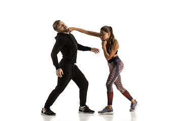 Image showing Man and woman fighting in studio, women\'s self-defense concept