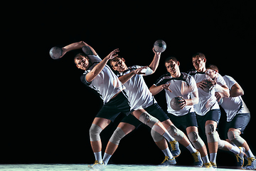 Image showing Young handball player against dark studio background in strobe light