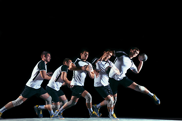 Image showing Young handball player against dark studio background in strobe light