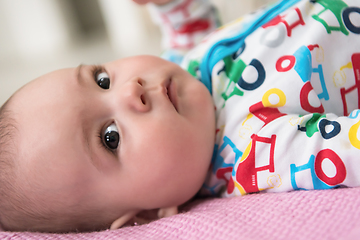 Image showing newborn baby boy lying on colorful blankets