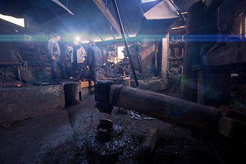 Image showing old mechanical hammer at blacksmith traditional workshop