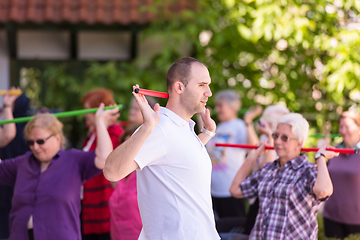 Image showing trainer training motivated active healthy senior people