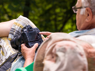 Image showing senior photographer preparing camera