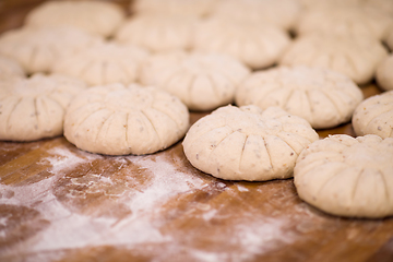 Image showing balls of dough bread getting ready to be baked