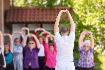 Image showing trainer training motivated active healthy senior people