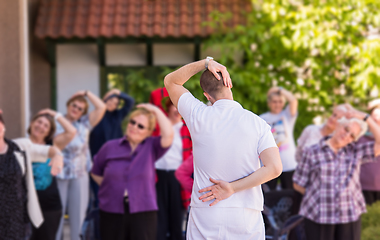 Image showing trainer training motivated active healthy senior people