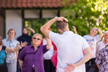 Image showing trainer training motivated active healthy senior people