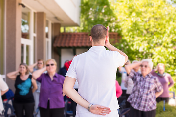 Image showing trainer training motivated active healthy senior people