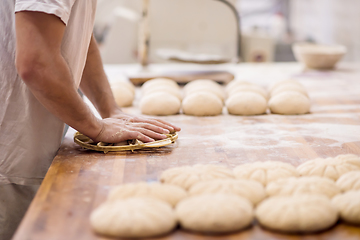 Image showing bakery worker preparing the dough