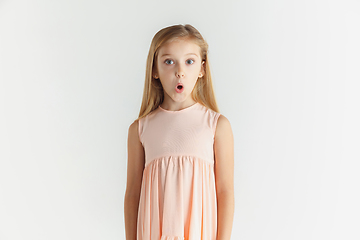 Image showing Little smiling girl posing in dress on white studio background