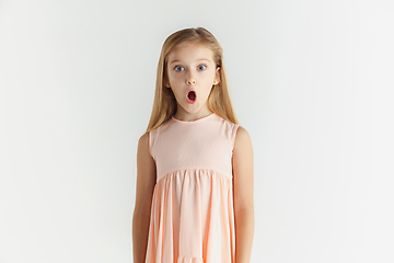 Image showing Little smiling girl posing in dress on white studio background