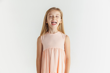 Image showing Little smiling girl posing in dress on white studio background