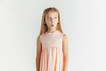 Image showing Little smiling girl posing in dress on white studio background