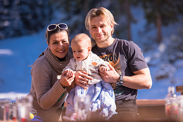 Image showing young happy family with little child enjoying winter day