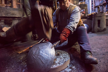 Image showing blacksmith workers using mechanical hammer at workshop