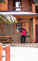 Image showing young man cooking meat on barbecue