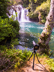 Image showing profesional DSLR camera on a tripod at beautiful waterfall