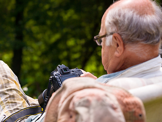 Image showing senior photographer preparing camera