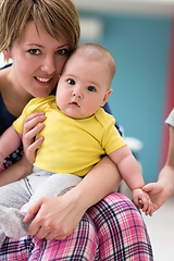 Image showing Portrait of young happy mother holding newborn baby boy