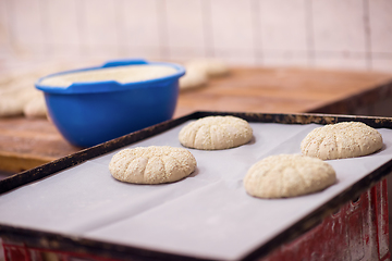 Image showing balls of dough bread getting ready to be baked