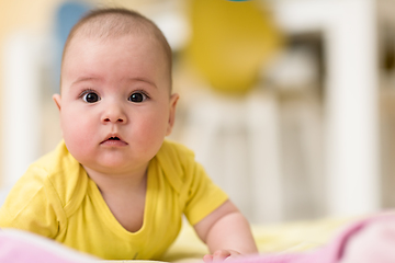 Image showing newborn baby boy playing on the floor