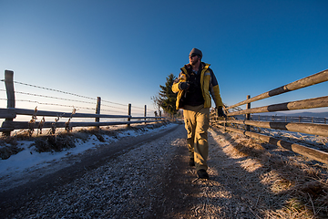 Image showing young photographer walking on country road