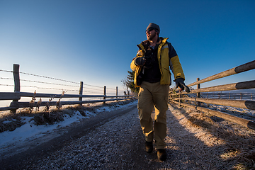 Image showing young photographer walking on country road