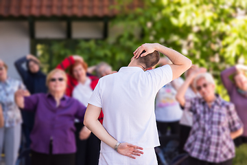 Image showing trainer training motivated active healthy senior people