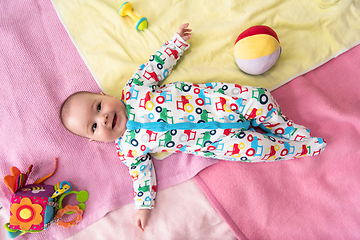 Image showing top view of newborn baby boy lying on colorful blankets