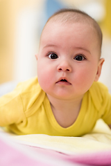 Image showing newborn baby boy playing on the floor