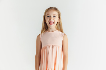 Image showing Little smiling girl posing in dress on white studio background