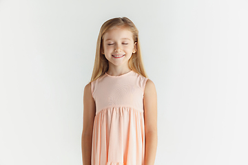 Image showing Little smiling girl posing in dress on white studio background