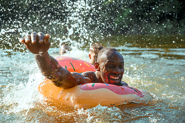 Image showing Happy man having fun, laughting and swimming in river